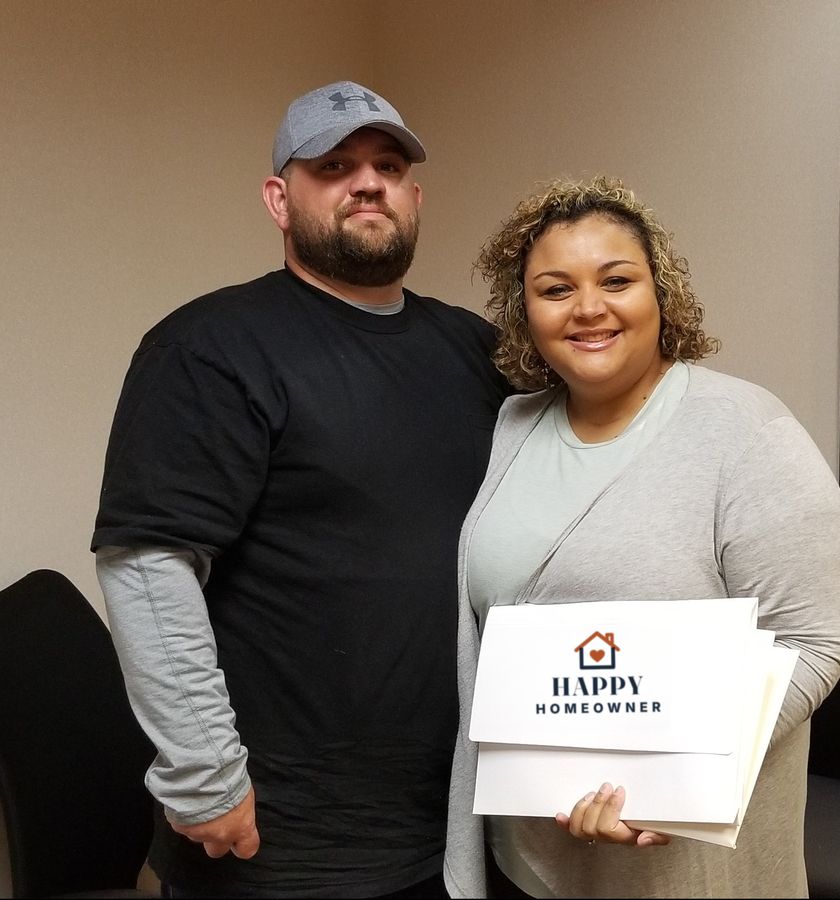 A couple holding their closing paperwork